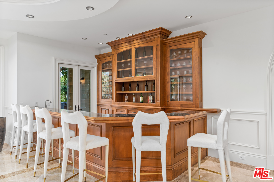 210 North Rockingham Avenue Los Angeles, CA 90049 - Photo 8 of 50 a view of a dining room with furniture and chandelier