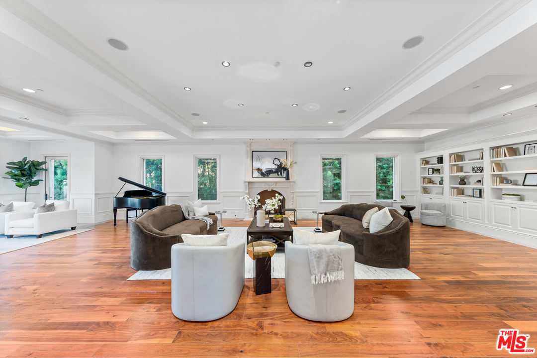 210 North Rockingham Avenue Los Angeles, CA 90049 - Photo 9 of 50 a living room with furniture and wooden floor