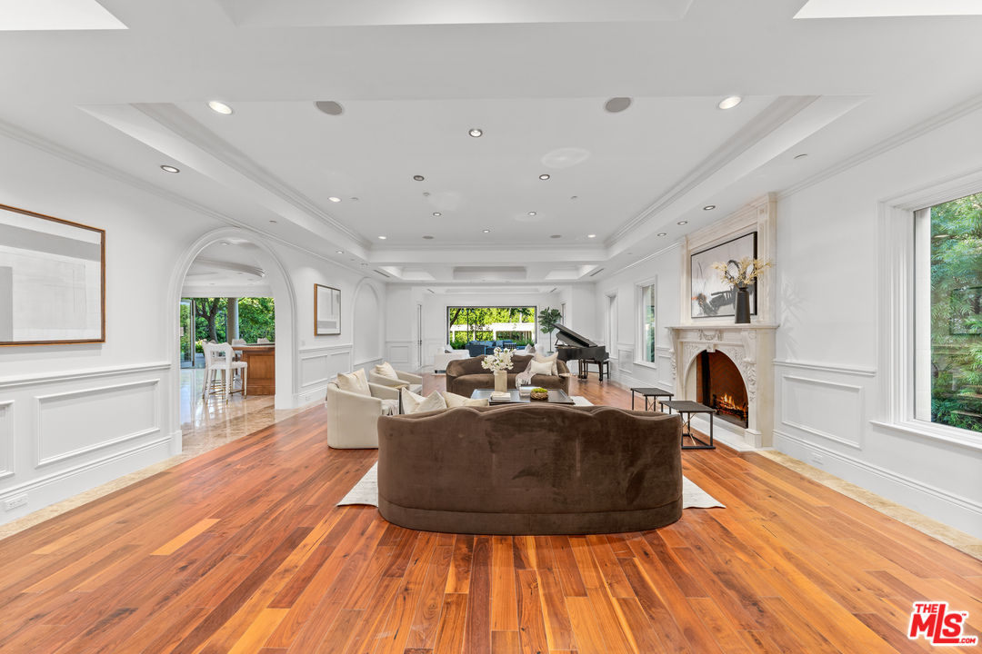 210 North Rockingham Avenue Los Angeles, CA 90049 - Photo 10 of 50 a living room with furniture a fireplace and a table