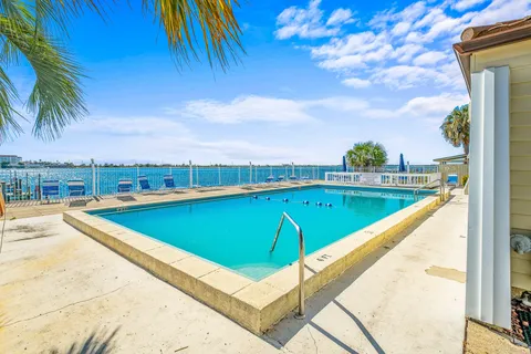 a view of a swimming pool with a lounge chair