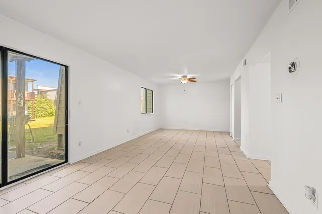 a view of a hallway with wooden floor and closet