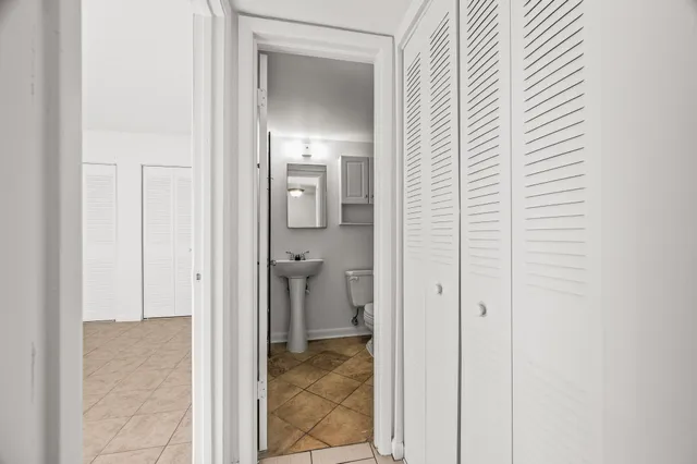 an empty room with windows and closet