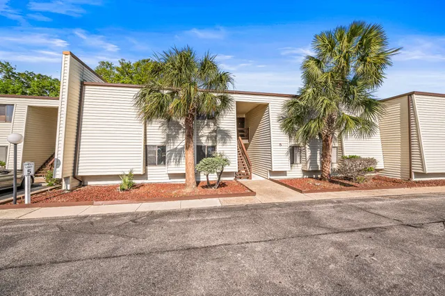a view of palm trees in front of a house