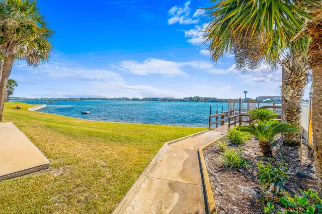 a front view of a house with a yard and potted plants