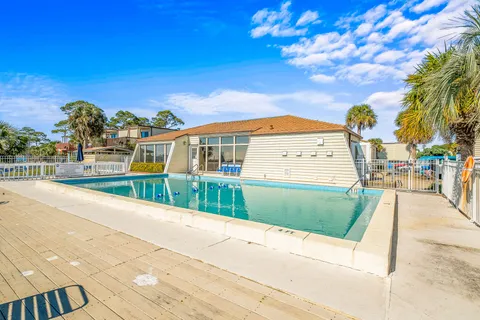 a living room with lots of furniture and a kitchen view
