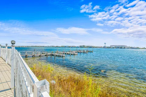 a living room with pool table and a potted plant
