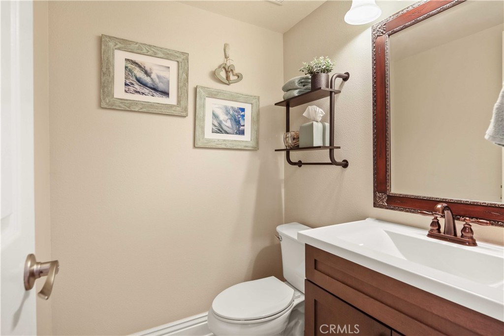 18836 Cedar Valley Way Newhall, CA 91321 - Photo 32 of 48 a bathroom with a sink a toilet and mirror