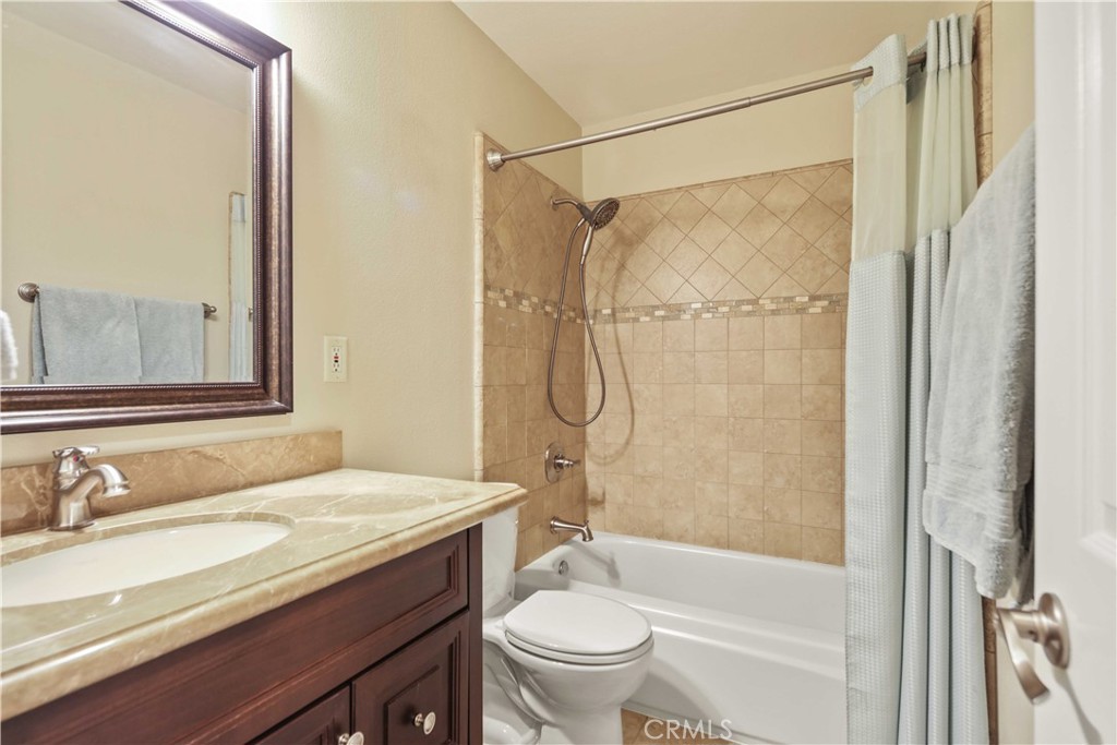 18836 Cedar Valley Way Newhall, CA 91321 - Photo 41 of 48 a bathroom with a granite countertop sink toilet and shower