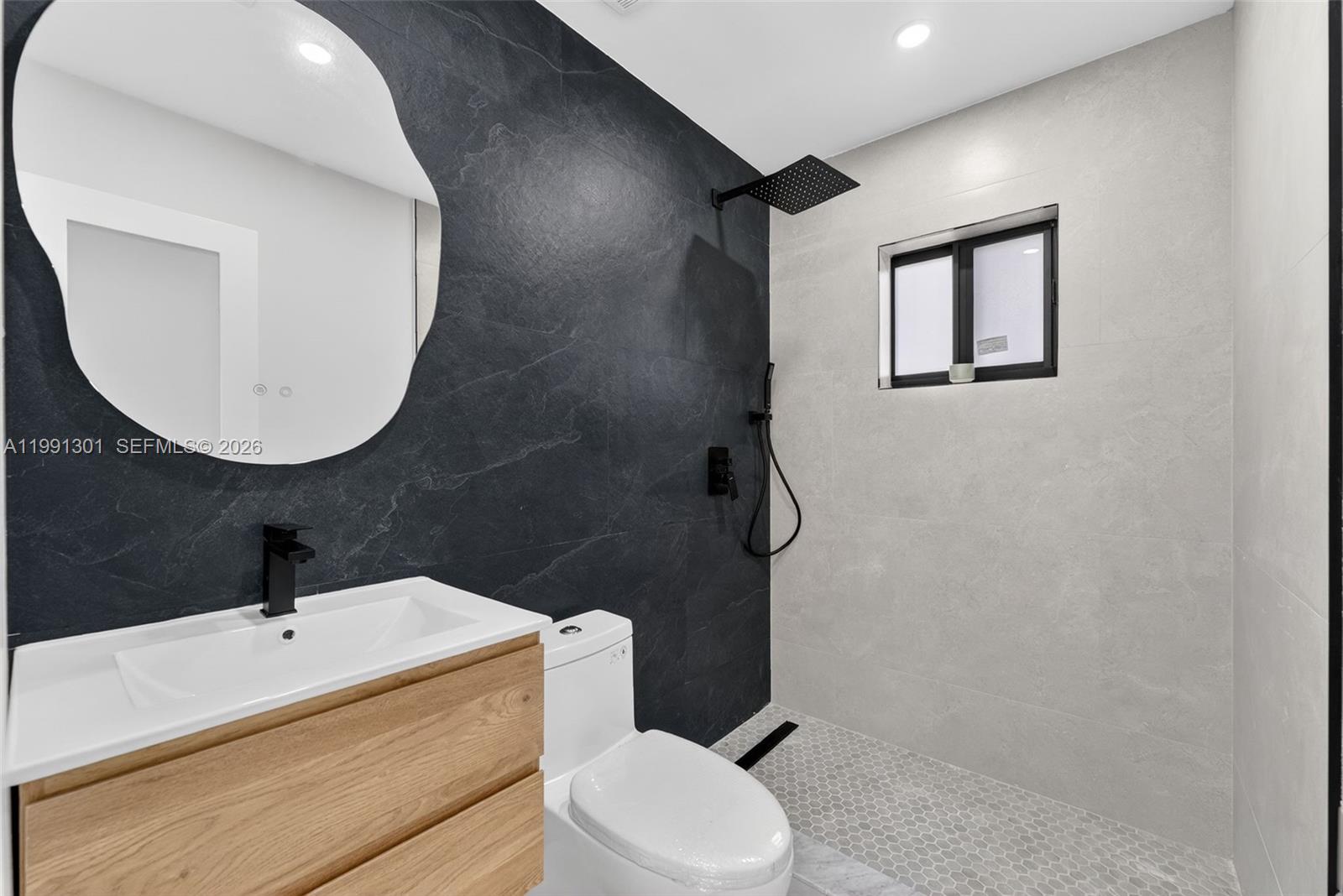 10445 Southwest 149th Terrace Miami, FL 33176 - Photo 13 of 19 a bathroom with a toilet a sink and mirror