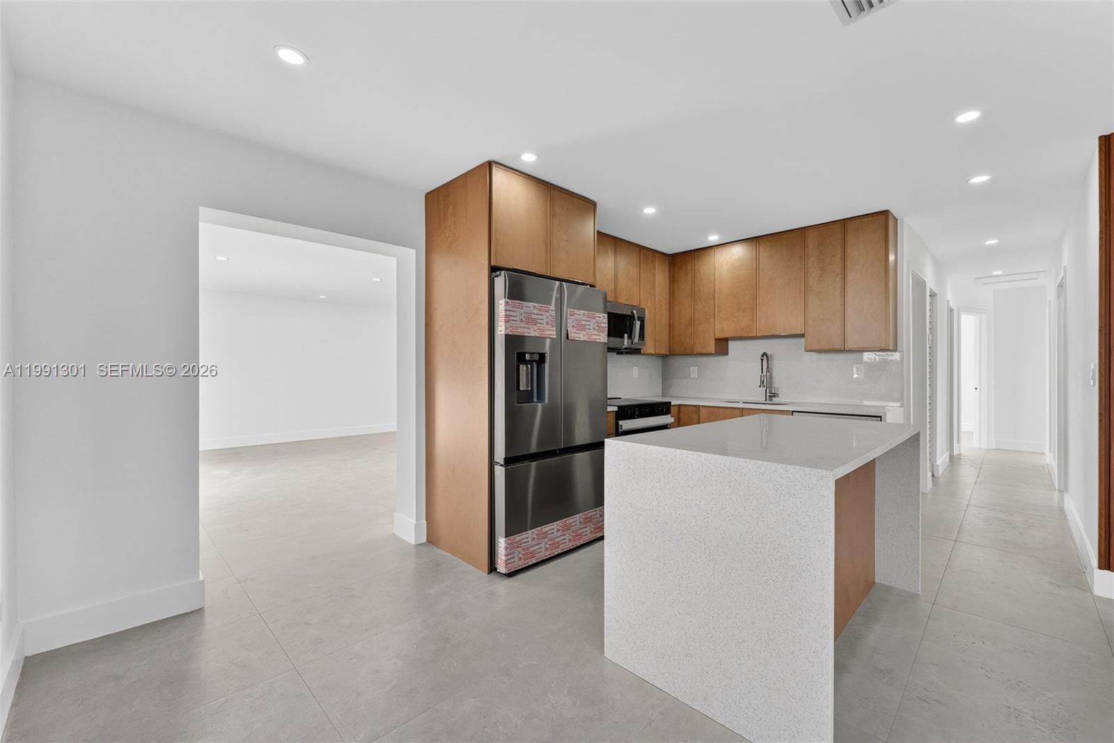 10445 Southwest 149th Terrace Miami, FL 33176 - Photo 5 of 19 a kitchen with stainless steel appliances granite countertop a refrigerator a sink and a stove