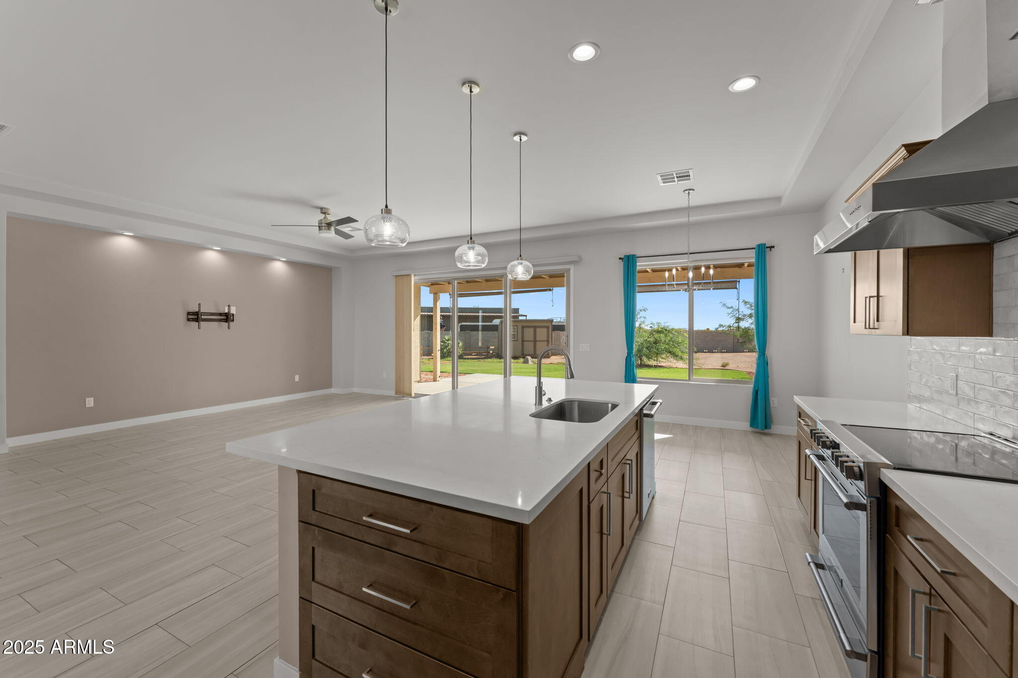 23012 Peak View Road Wittmann, AZ 85361 - Photo 11 of 44 a kitchen with a stove a sink and a refrigerator