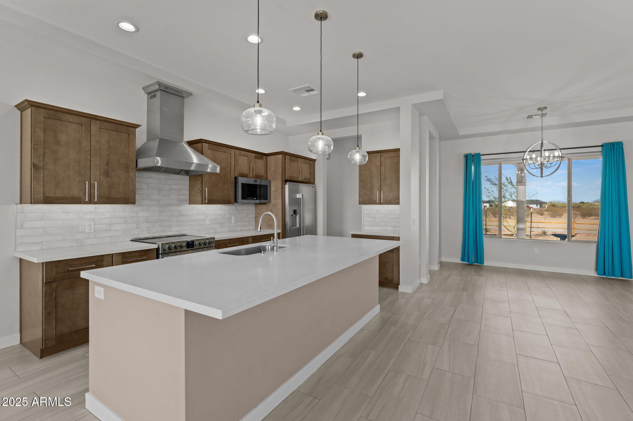23012 Peak View Road Wittmann, AZ 85361 - Photo 2 of 44 a large kitchen with stainless steel appliances granite countertop a sink a stove and a refrigerator