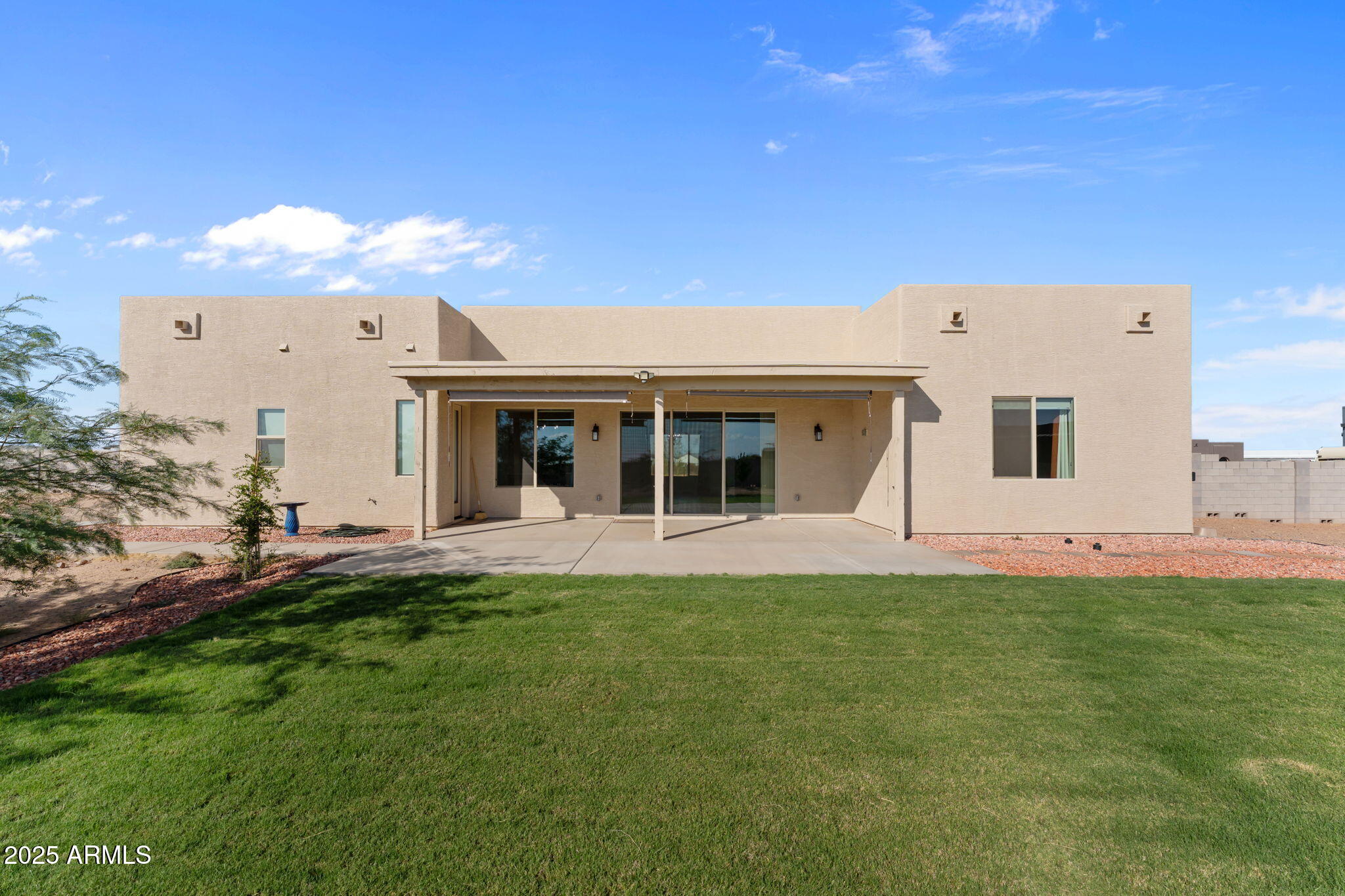 23012 Peak View Road Wittmann, AZ 85361 - Photo 31 of 44 a front view of a house with a garden and yard