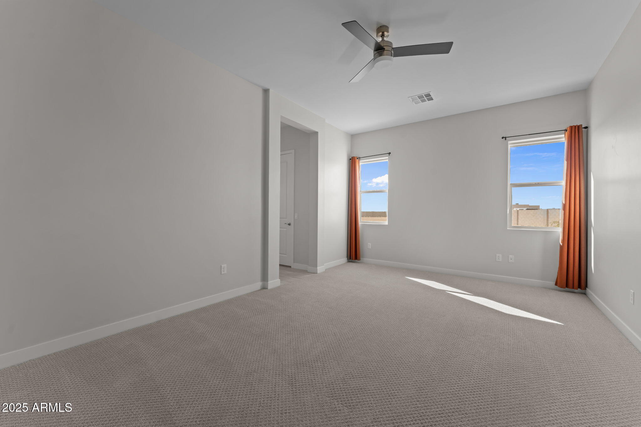23012 Peak View Road Wittmann, AZ 85361 - Photo 3 of 44 an empty room with windows and fan