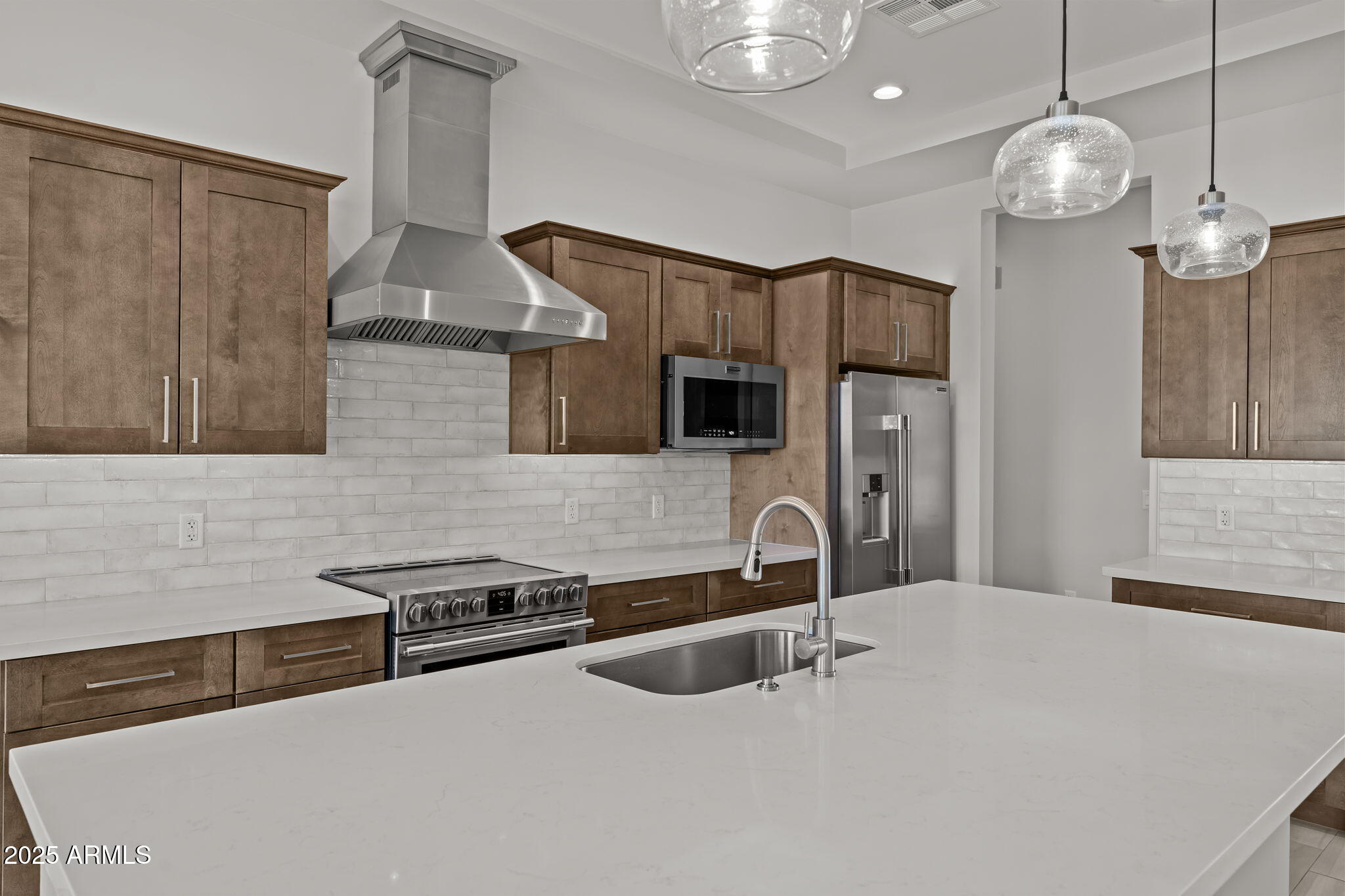 23012 Peak View Road Wittmann, AZ 85361 - Photo 7 of 44 a kitchen with stainless steel appliances a sink a stove and a refrigerator