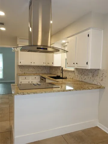 a backyard of a house with lawn chairs and wooden fence