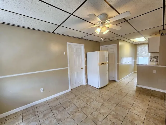 a view of a kitchen with a refrigerator and a sink