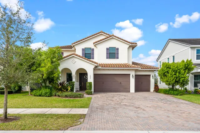 a front view of a house with a yard and garage