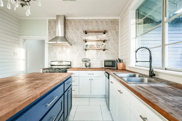 a kitchen with a sink stove and cabinets
