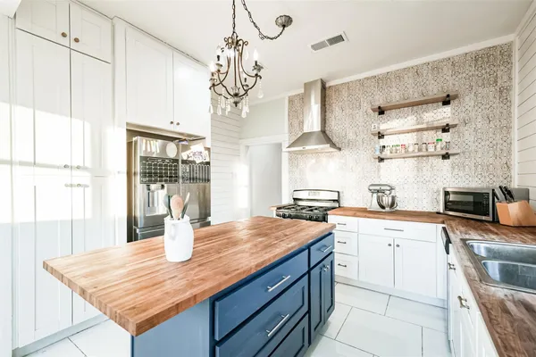 a kitchen with stainless steel appliances granite countertop a sink a stove and a refrigerator