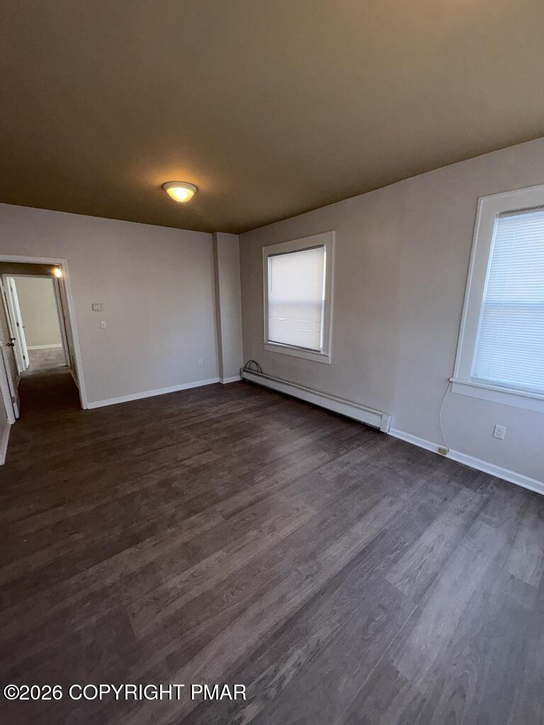 532 Cherry Street, Unit A Scranton, PA 18505 - Photo 17 of 23 an empty room with wooden floor and windows
