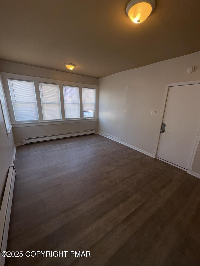 532 Cherry Street, Unit A Scranton, PA 18505 - Photo 8 of 23 an empty room with wooden floor and windows