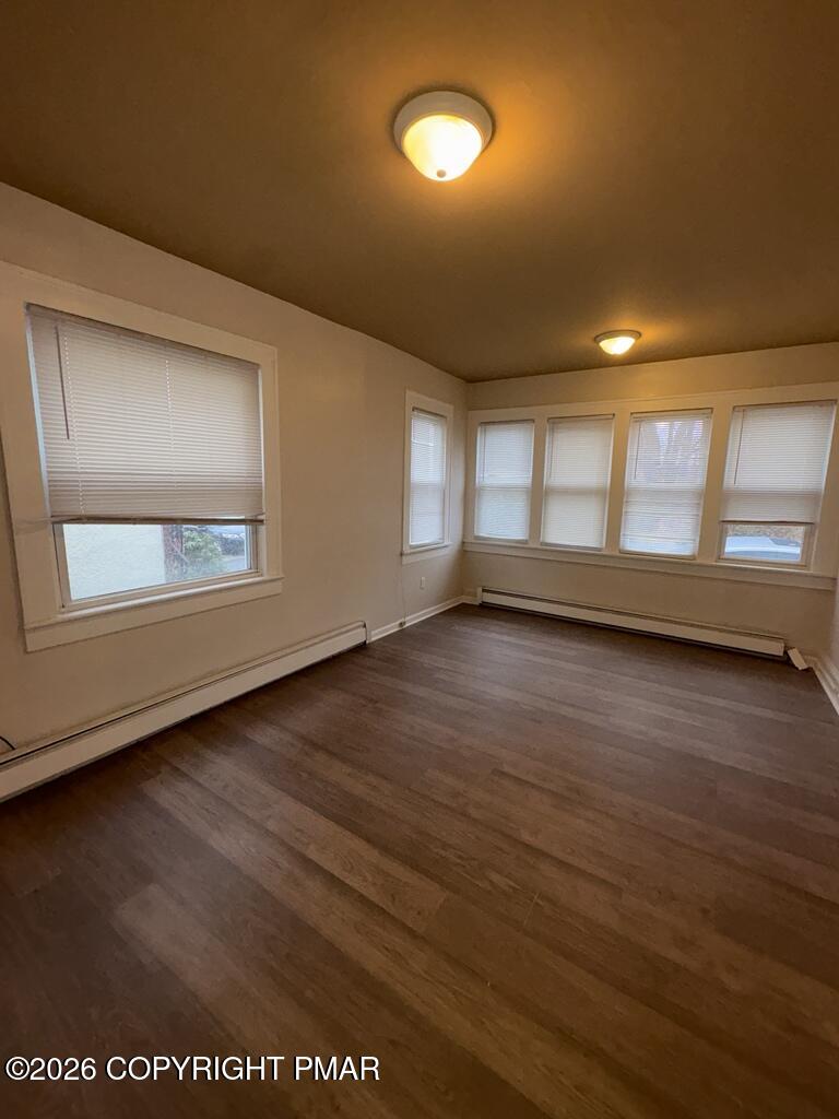 532 Cherry Street, Unit A Scranton, PA 18505 - Photo 9 of 23 an empty room with wooden floor and windows