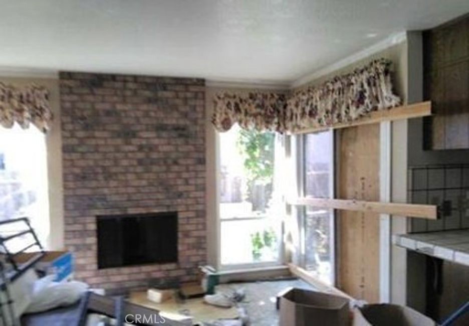7143 Shoreham Place Stockton, CA 95207 - Photo 3 of 7 a living room with furniture a window and a fireplace