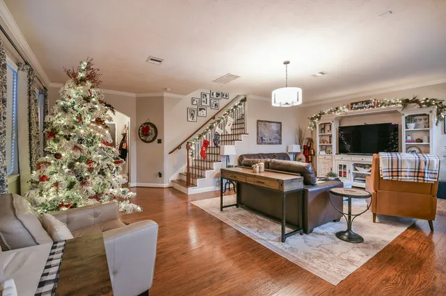 a living room with furniture kitchen view and a flat screen tv