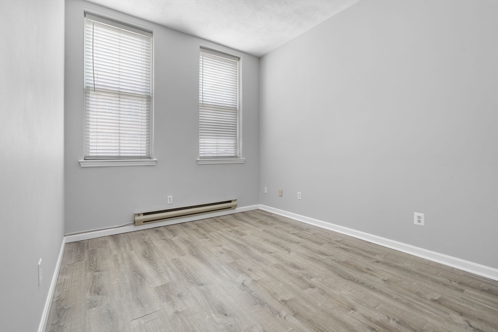 19 Washington Street, Unit 2 Haverhill, MA 01832 - Photo 11 of 20 an empty room with wooden floor and windows
