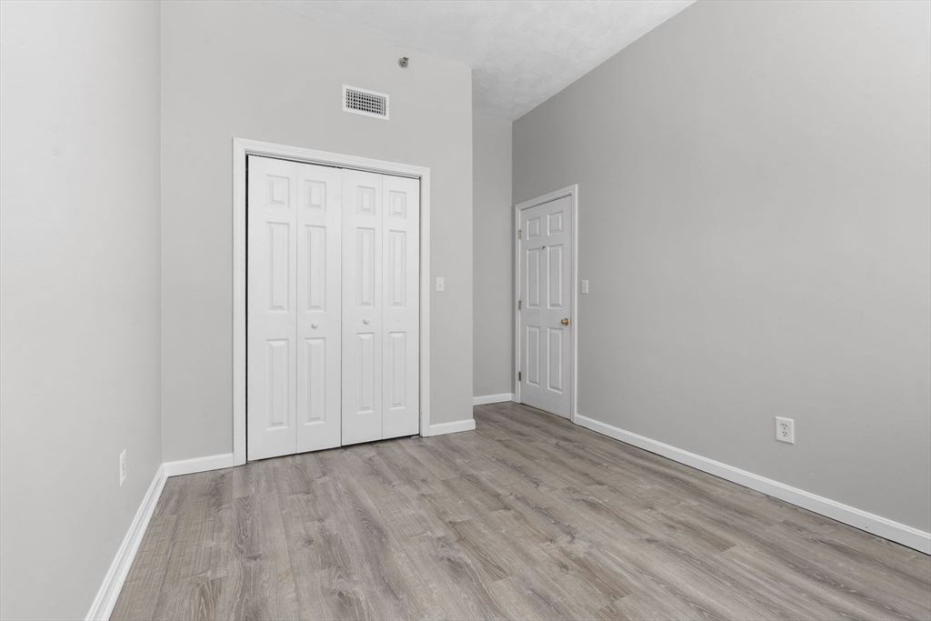 19 Washington Street, Unit 2 Haverhill, MA 01832 - Photo 13 of 20 a view of an empty room with wooden floor