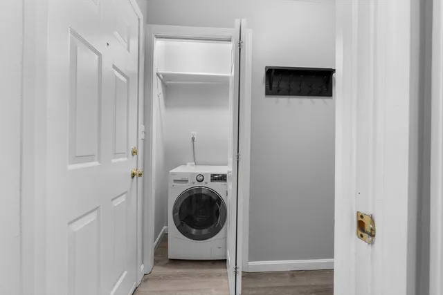 a view of a hallway with washer and dryer