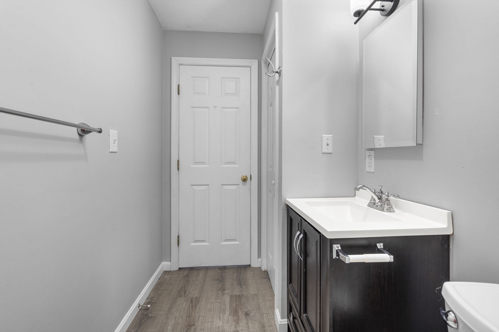 19 Washington Street, Unit 2 Haverhill, MA 01832 - Photo 5 of 20 a bathroom with a sink a toilet and a mirror
