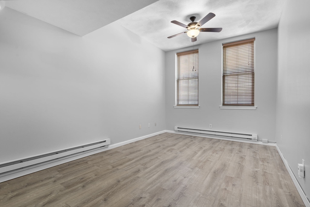19 Washington Street, Unit 2 Haverhill, MA 01832 - Photo 6 of 20 wooden floor in an empty room with a window