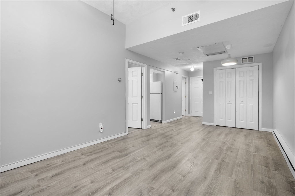 19 Washington Street, Unit 2 Haverhill, MA 01832 - Photo 9 of 20 a view of an empty room with wooden floor