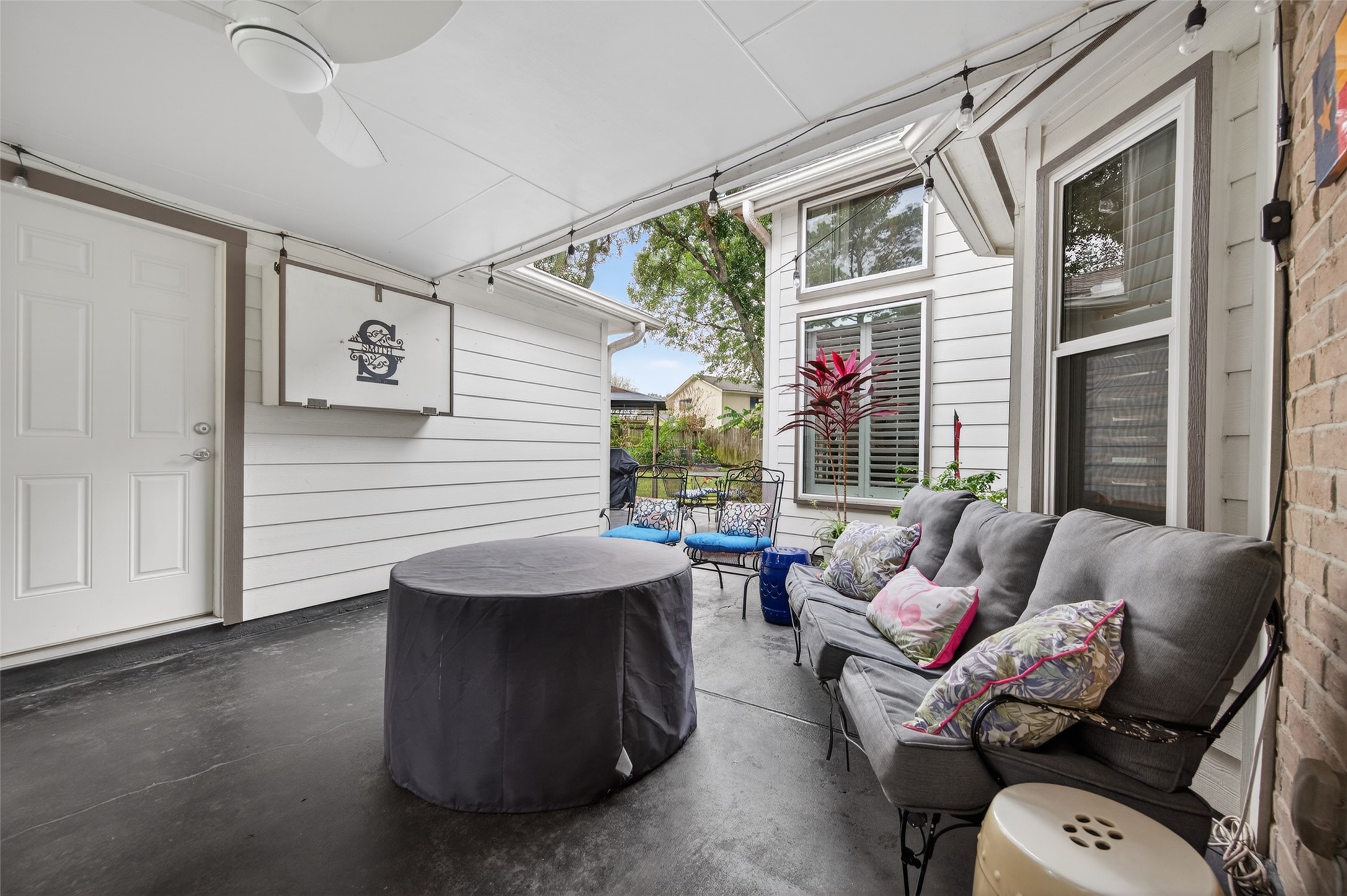 7310 Maidstone Lane Houston, TX 77095 - Photo 30 of 40 Covered outdoor back patio between the home and garage that has a TV with a cover that stays with the property.
