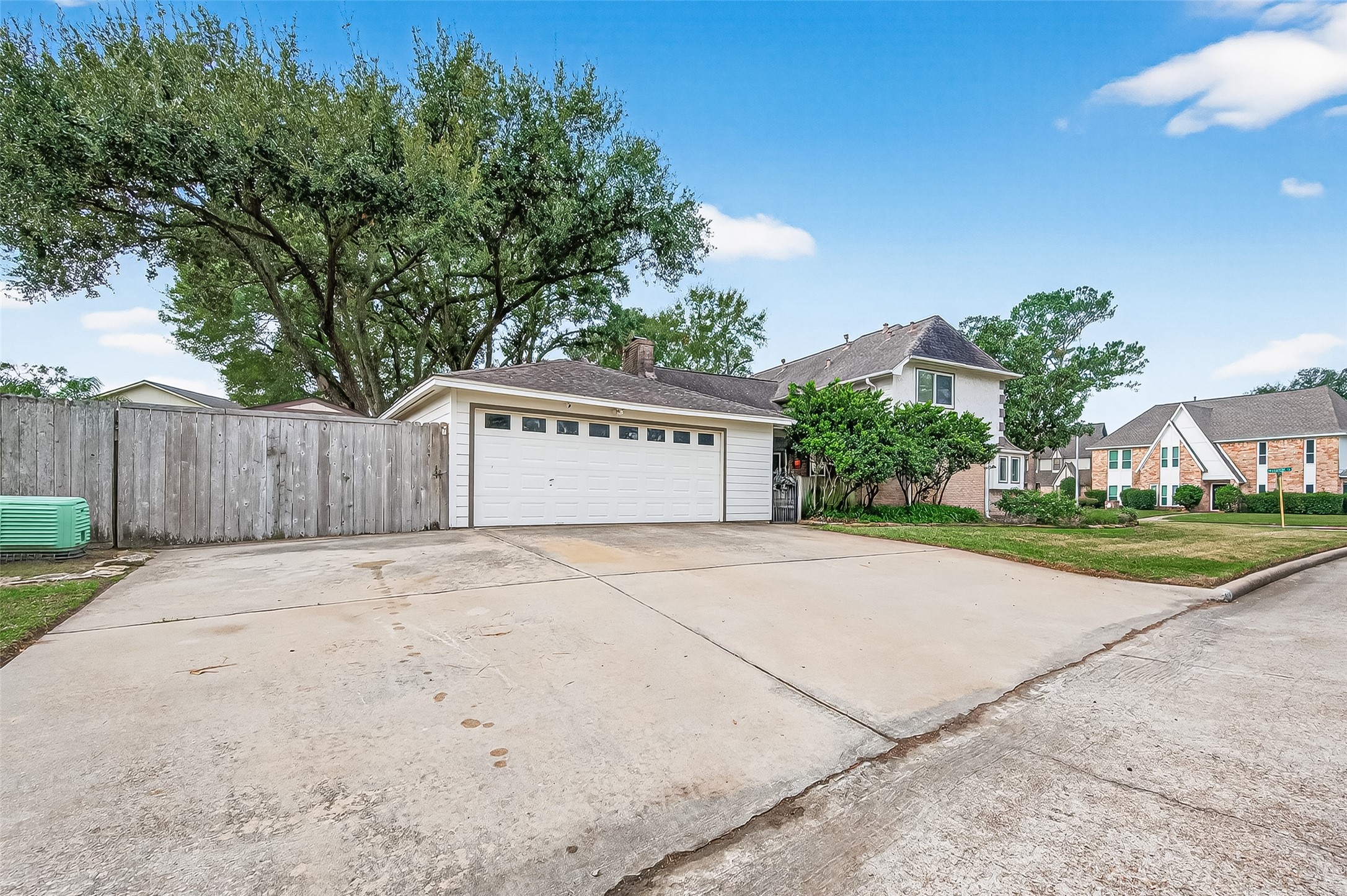 7310 Maidstone Lane Houston, TX 77095 - Photo 35 of 40 Detached garage with 3 full driveway spaces for extra parking. The driveway to the left extends to the backyard and there is a gate for access.