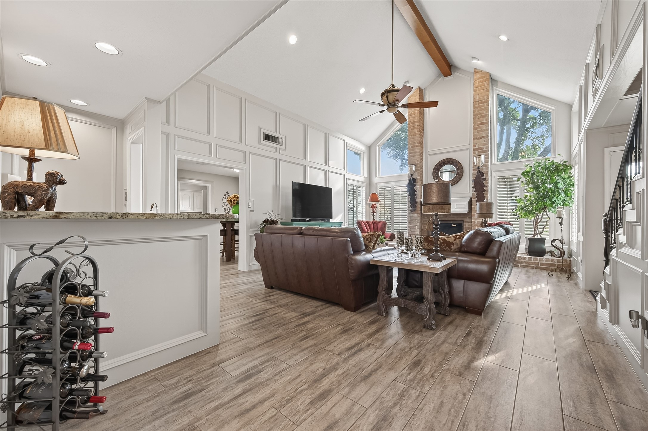7310 Maidstone Lane Houston, TX 77095 - Photo 4 of 40 Breathtaking family room (20X17) with high, vaulted ceilings gets tons of natural light through the large windows with views of the backyard. Wet bar is off to the left.