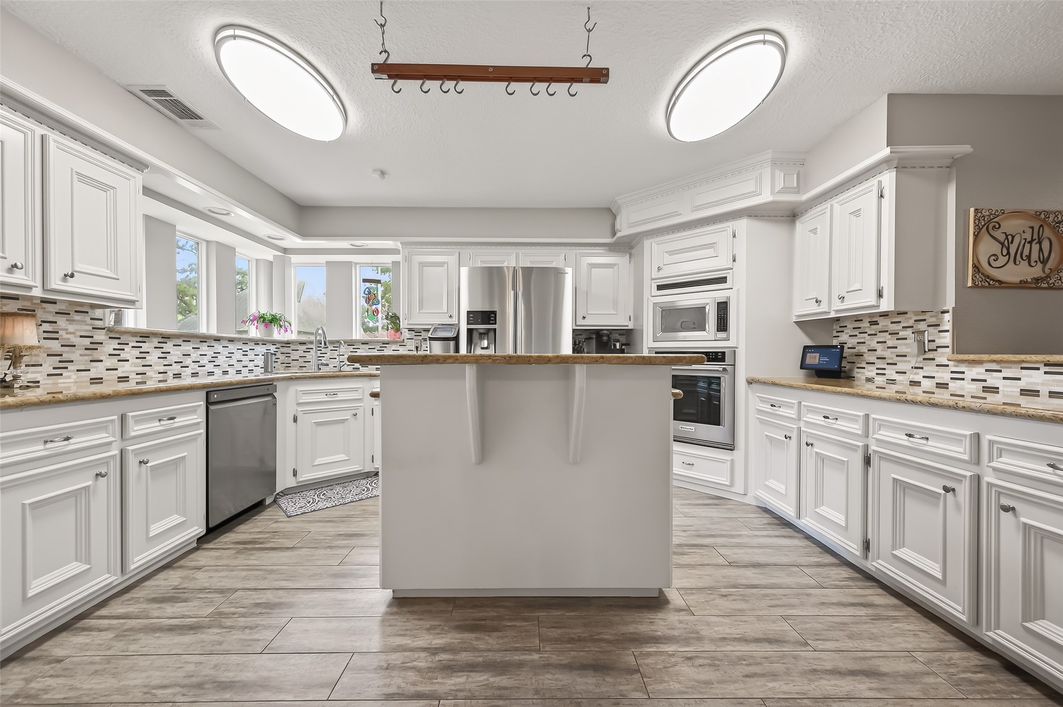 7310 Maidstone Lane Houston, TX 77095 - Photo 9 of 40 Notice the beautiful windows in the corner above the sink which adds great light.