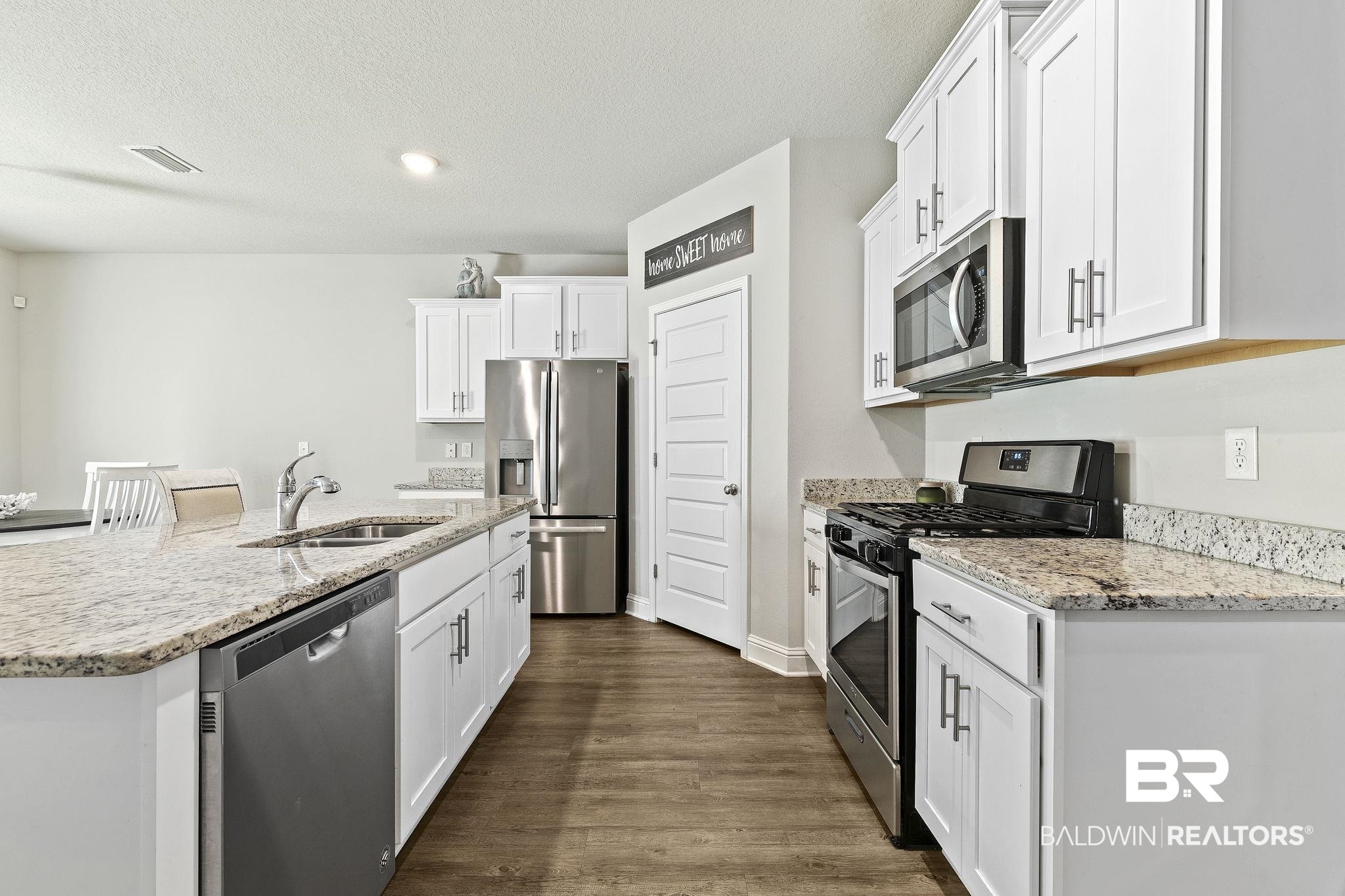 31610 Memphis Loop Daphne, AL 36527 - Photo 13 of 67 Kitchen with a sink, stainless steel appliances, visible vents, and white cabinetry