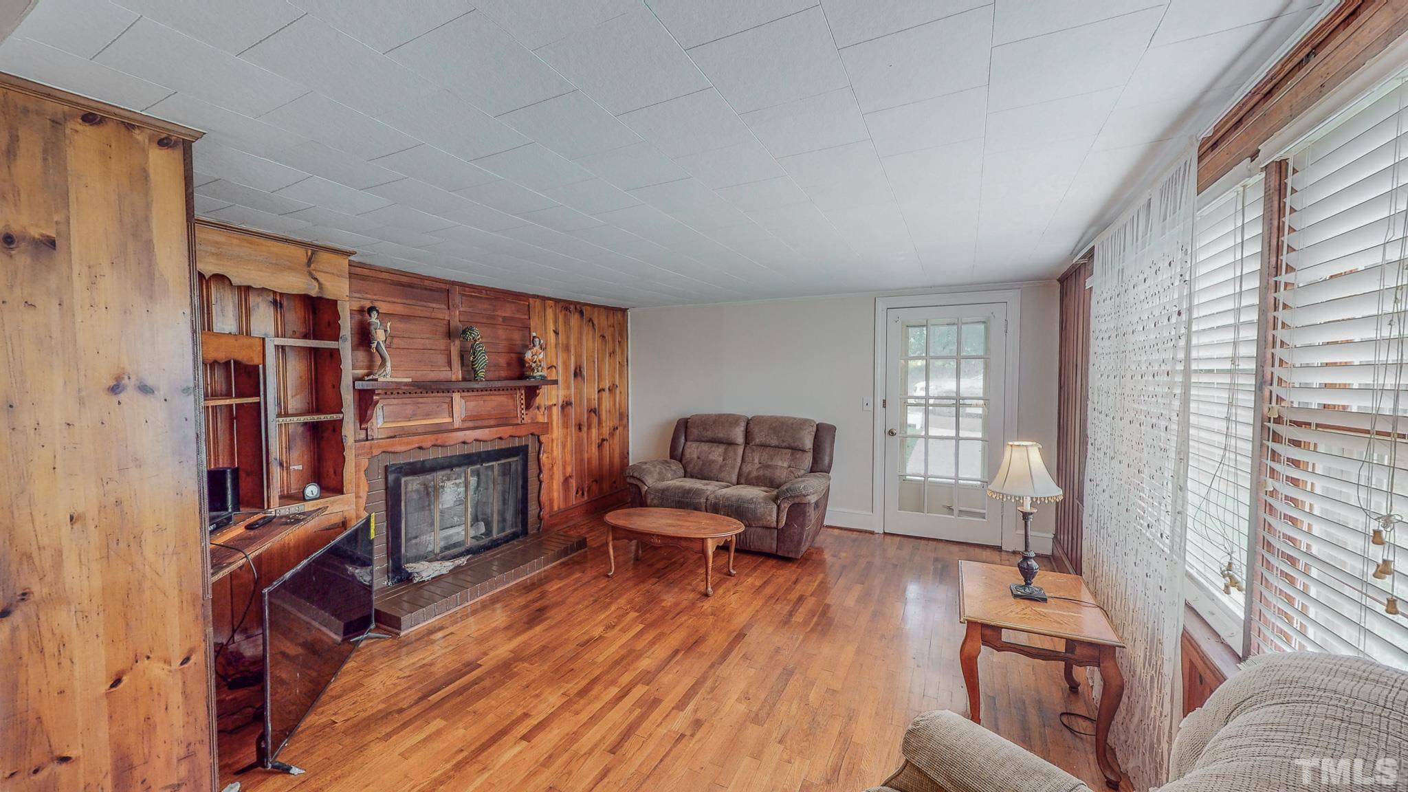1556 Gentry-Dunkley Road Roxboro, NC 27574 - Photo 11 of 47 a living room with furniture a fireplace and a large window