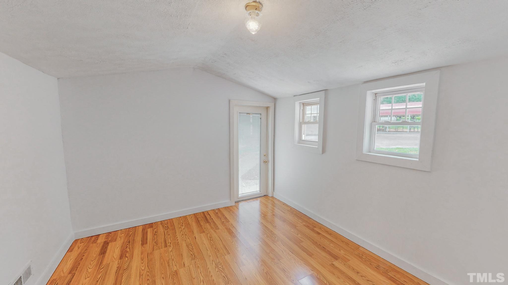 1556 Gentry-Dunkley Road Roxboro, NC 27574 - Photo 13 of 47 a view of empty room with wooden floor