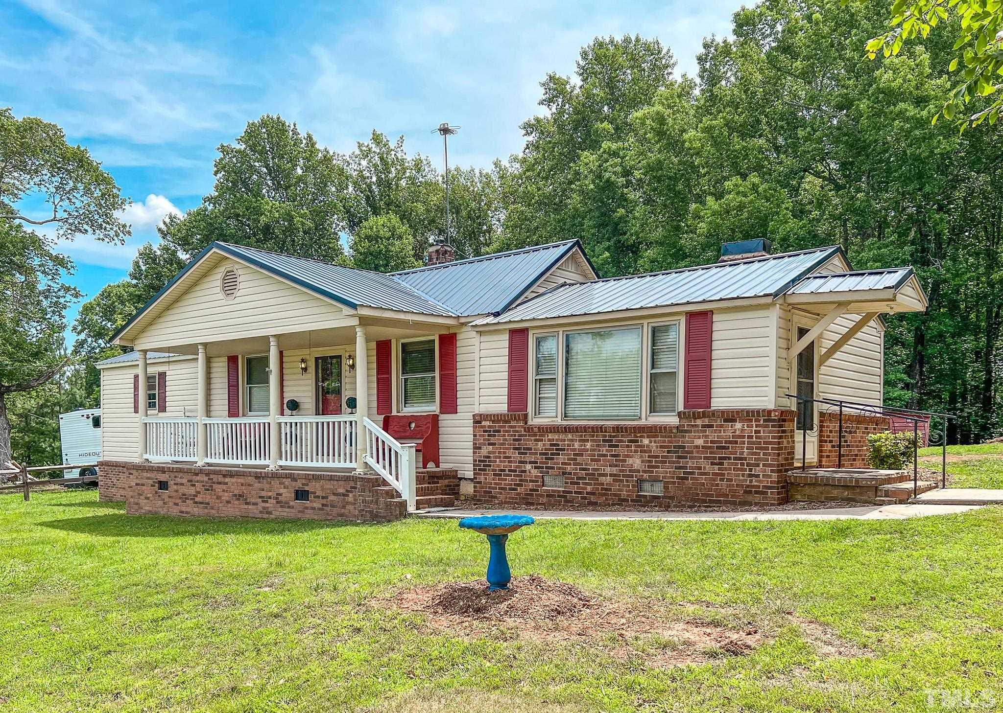 1556 Gentry-Dunkley Road Roxboro, NC 27574 - Photo 17 of 47 a front view of a house with a yard