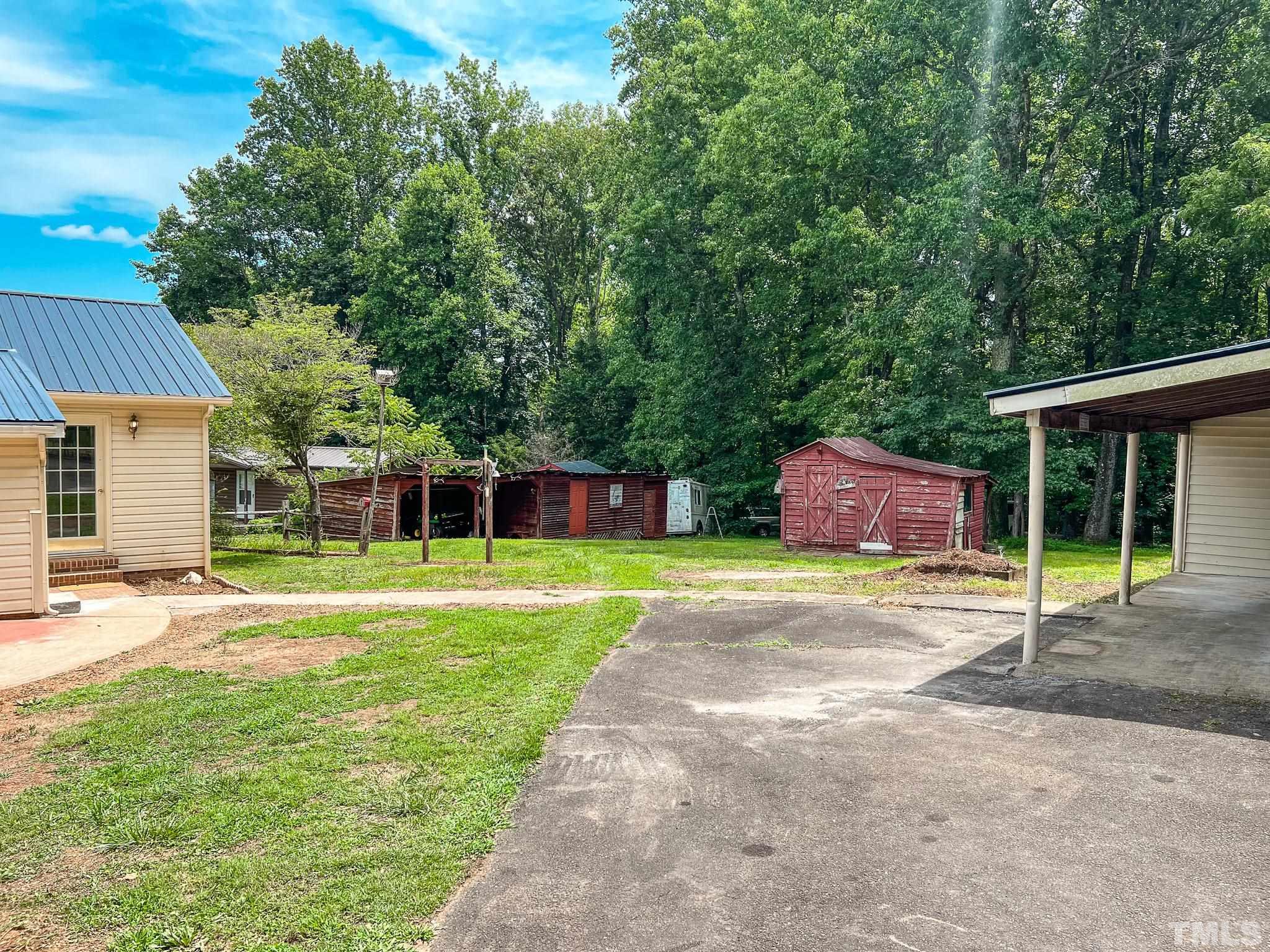 1556 Gentry-Dunkley Road Roxboro, NC 27574 - Photo 19 of 47 a house with swimming pool in front of it