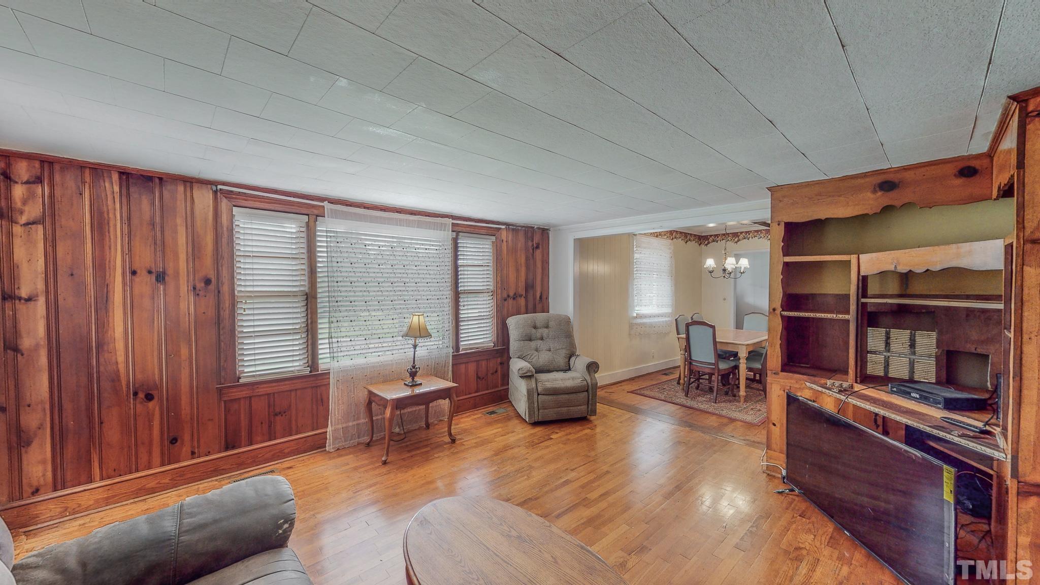 1556 Gentry-Dunkley Road Roxboro, NC 27574 - Photo 20 of 47 a living room with furniture a bookshelf and a window