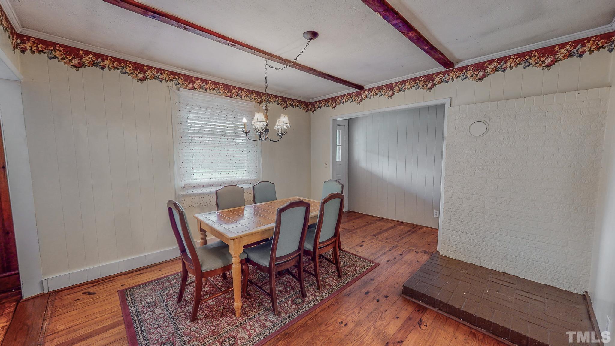 1556 Gentry-Dunkley Road Roxboro, NC 27574 - Photo 21 of 47 a view of a dining room with furniture and wooden floor
