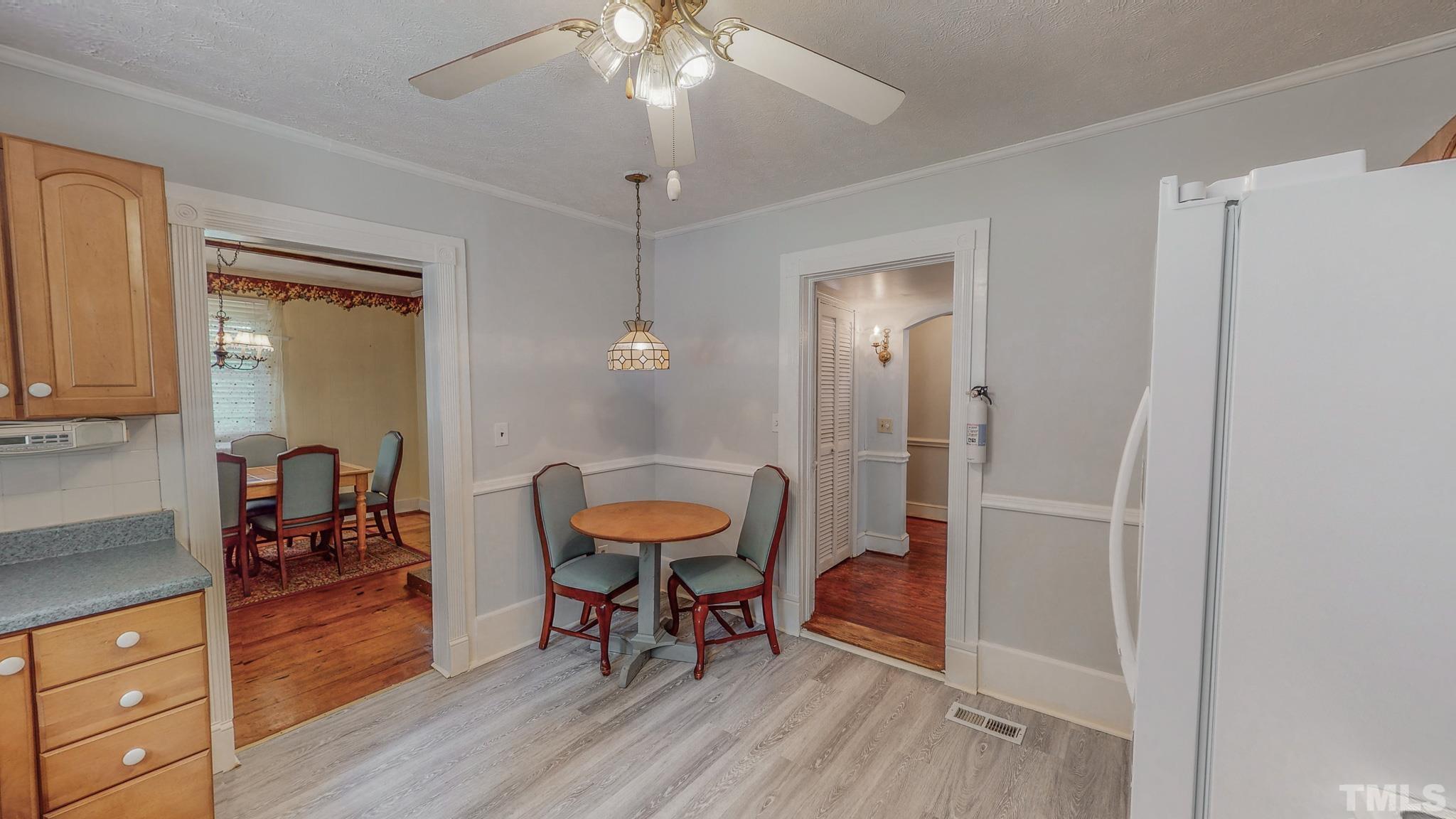 1556 Gentry-Dunkley Road Roxboro, NC 27574 - Photo 24 of 47 a view of a dining room with furniture and wooden floor