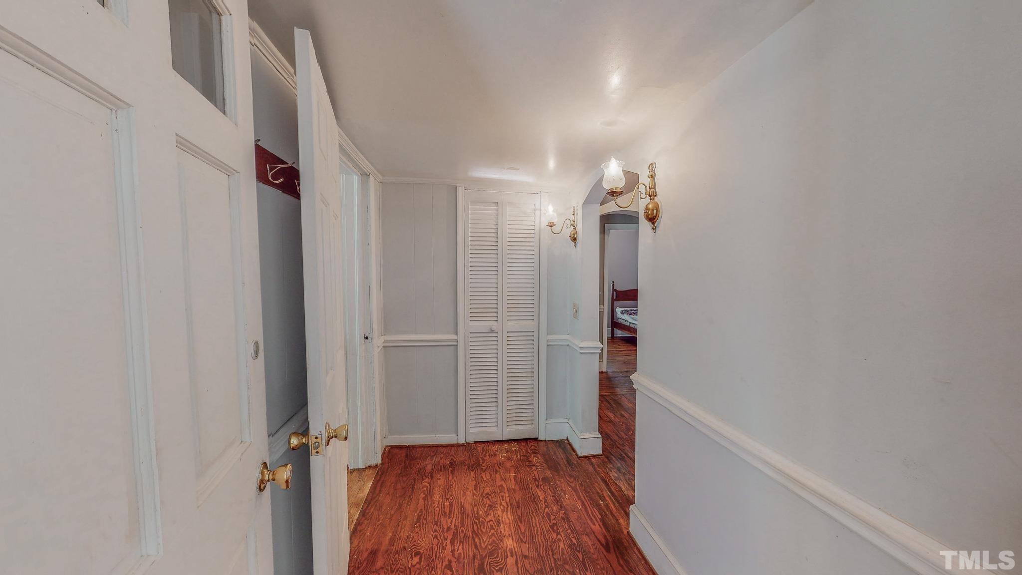 1556 Gentry-Dunkley Road Roxboro, NC 27574 - Photo 26 of 47 a view of a hallway with wooden floor and staircase