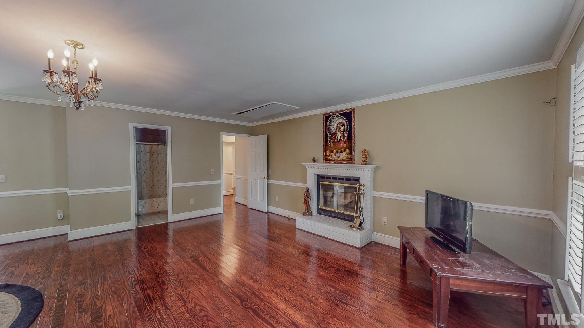 1556 Gentry-Dunkley Road Roxboro, NC 27574 - Photo 29 of 47 a view of a livingroom with wooden floor a fireplace and window