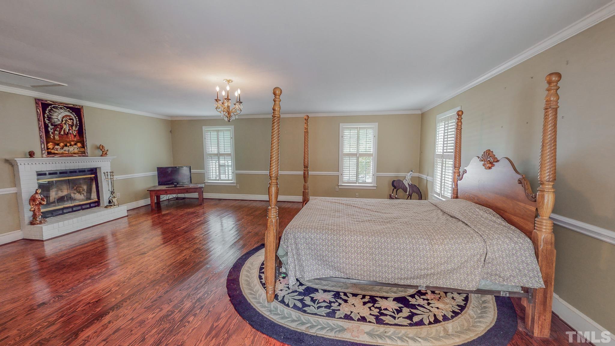 1556 Gentry-Dunkley Road Roxboro, NC 27574 - Photo 33 of 47 a bed room with a bed and a fireplace